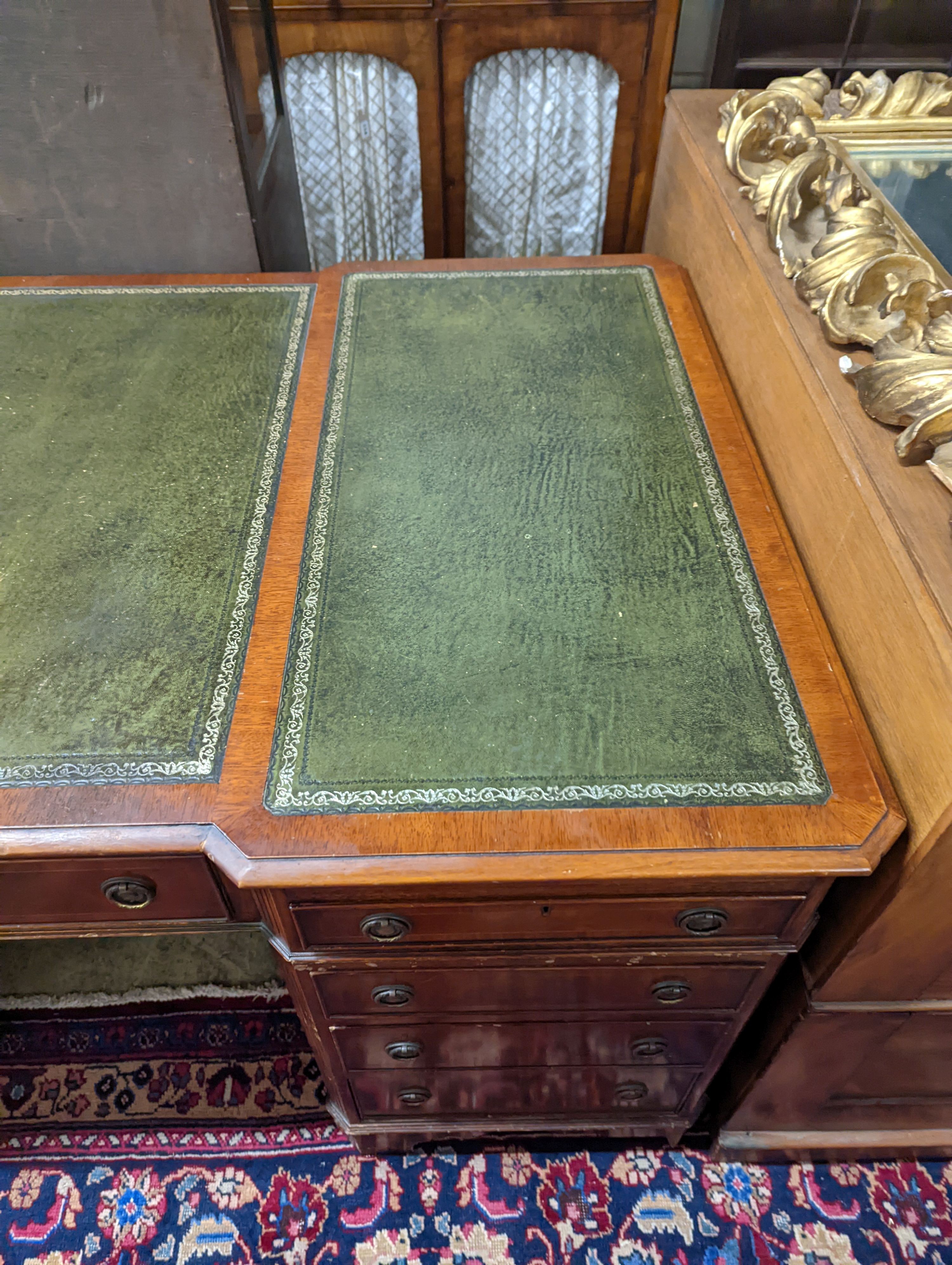 A reproduction George III style mahogany pedestal desk, length 150cm, depth 90cm, height 76cm